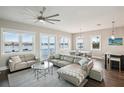 Living room with water view, sectional sofa and access to balcony at 339 55Th Ave, St Pete Beach, FL 33706