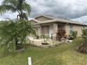 Tan house with palm trees and well-maintained landscaping at 6812 Aramon Ct, Wesley Chapel, FL 33545