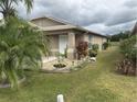 Tan house with landscaping and walkway at 6812 Aramon Ct, Wesley Chapel, FL 33545
