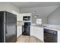 Modern kitchen with black appliances at 3776 Junction St, North Port, FL 34288