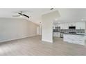 Modern kitchen with white cabinets, granite island and stainless steel appliances at 4501 Harrington St, Port Charlotte, FL 33948