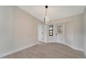 Bright dining room with modern light fixture and wood-look floors at 4501 Harrington St, Port Charlotte, FL 33948