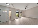 Spacious living room featuring large windows and wood-look floors at 4501 Harrington St, Port Charlotte, FL 33948