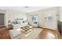 Living Room with light wood floors and white furniture at 4627 Ardale St, Sarasota, FL 34232