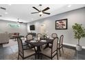 Bright dining area features a dark wood table with six chairs and decorative accents at 8448 Red Roe Dr, New Port Richey, FL 34653
