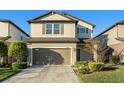 Two-story house with neutral siding, brown garage door, and manicured landscaping at 7779 Yale Harbor Dr, Wesley Chapel, FL 33545