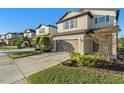 Two-story house with neutral siding, brown garage door, and manicured landscaping at 7779 Yale Harbor Dr, Wesley Chapel, FL 33545