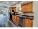 Kitchen with wood cabinets, granite counters, and stainless steel appliances at 2699 Seville Blvd # 303, Clearwater, FL 33764