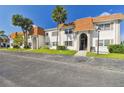 Side view of a condo building showcasing its light-colored facade and landscaping at 345 S Mcmullen Booth Rd # 142, Clearwater, FL 33759