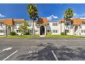 Front view of a condo building, featuring a clean design and palm trees at 345 S Mcmullen Booth Rd # 142, Clearwater, FL 33759