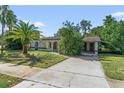 House exterior with a driveway and landscaping at 7128 Spring Hill Dr, Spring Hill, FL 34606