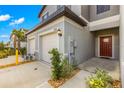 Townhome exterior showcasing a two-car garage and front entrance at 8222 Corner Pine Way, New Port Richey, FL 34655