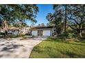 Condo exterior, two-car garage, and green lawn at 4399 Brooker Creek Dr, Palm Harbor, FL 34685