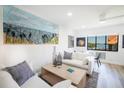 Living area with comfy sofas, wood floors, and coastal decor at 1515 Pinellas Bayway S # B28, Tierra Verde, FL 33715