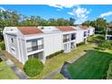 Exterior view of a condo building with lush landscaping at 2060 Marilyn St # 238, Clearwater, FL 33755