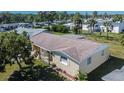 Aerial view of a single-story house with a brown roof and a green lawn at 10801 Fillmore Ave, Port Richey, FL 34668