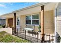 Inviting front porch with a metal bench and decorative columns at 10801 Fillmore Ave, Port Richey, FL 34668
