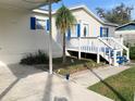 Front view of a single story home with a carport and blue accents at 15301 16Th St, Dade City, FL 33523