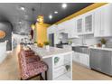 Modern kitchen with white cabinets, stainless steel appliances, and a large island at 120 Brightwater Dr # 2, Clearwater Beach, FL 33767