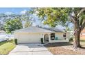 One-story home with light yellow exterior and attached garage at 5141 Abagail Dr, Spring Hill, FL 34608