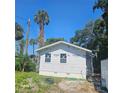 Newly constructed home with gray siding and white trim at 5831 Michigan Ave, New Port Richey, FL 34652