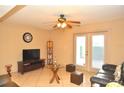 Living room with tiled floors, TV, and glass coffee table at 117 114Th N Ave # 117, St Petersburg, FL 33716