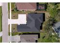 Top-down view of a house with a black roof and a paver driveway at 4716 Hickory Oak Dr, Brooksville, FL 34601