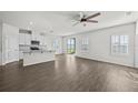 Modern kitchen with white cabinets, granite countertops, and island at 8852 Prairie Creek Dr, New Port Richey, FL 34655