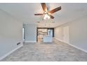 Open-concept living area with tile flooring, ceiling fan, and view of the kitchen at 664 Frederica Ln, Dunedin, FL 34698