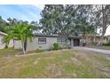 Charming single-story home with a landscaped front yard and attached garage at 664 Frederica Ln, Dunedin, FL 34698
