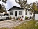 White house with gray trim, a driveway, and potted plants at 3102 W Leroy St # A, Tampa, FL 33607