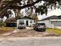 Two-vehicle driveway with a house and large tree at 3102 W Leroy St # A, Tampa, FL 33607