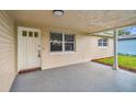 Covered entryway with white door and window, offering curb appeal at 3525 Umber Rd, Holiday, FL 34691