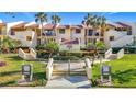 Condominium complex with tropical landscaping, palm trees, and a charming entrance sign at 7520 Sunshine Skyway S Ln # 210, St Petersburg, FL 33711