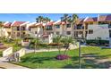 Exterior image of the condo complex showing well-maintained grounds and tropical landscaping at 7520 Sunshine Skyway S Ln # 210, St Petersburg, FL 33711
