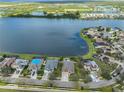 Breathtaking aerial view of waterfront homes nestled along a serene lake, creating a tranquil and picturesque community at 805 Seminole Sky Dr, Ruskin, FL 33570
