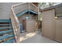 Back patio with stairs, deck, and storage shed at 1106 Lennox W Rd, Palm Harbor, FL 34683