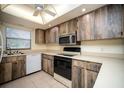 Kitchen with wood cabinets, stainless steel appliances, and light countertops at 101 Lake Ne Ave # 211, Largo, FL 33771