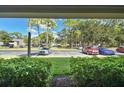 View from patio showcasing lush landscaping and parking at 36750 Us Highway 19 N # 09110, Palm Harbor, FL 34684