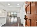 Bright condo entryway with hardwood floors and view to living room at 36750 Us Highway 19 N # 04208, Palm Harbor, FL 34684