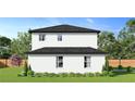 Two-story home showcasing the backyard and landscaping at 12905 Worchester Ave, Tampa, FL 33624