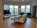 Bright living room with a large window view and a white sectional sofa at 1209 E Cumberland Ave # 508, Tampa, FL 33602