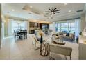 Open concept living room and kitchen with modern design at 30200 Southernwood Ct, Wesley Chapel, FL 33543