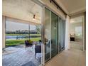 Relaxing screened-in patio overlooking a peaceful lake, perfect for outdoor enjoyment at 30200 Southernwood Ct, Wesley Chapel, FL 33543