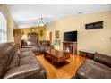 Living room with brown leather furniture and wood floors at 6703 Pistachio St, Zephyrhills, FL 33542