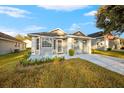 Front view of a single-story house with a gray garage door at 6703 Pistachio St, Zephyrhills, FL 33542