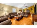 Spacious living room with brown couches and a fireplace at 6703 Pistachio St, Zephyrhills, FL 33542