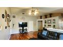 Spacious living room with hardwood floors, a TV, and a ceiling fan at 6605 Summer Haven Dr, Riverview, FL 33578