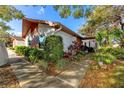 Charming single story home with brick and siding, beautifully landscaped yard and inviting entryway at 2390 Shelly Dr # D, Palm Harbor, FL 34684