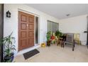 Inviting covered front porch with tiled flooring and outdoor seating at 2390 Shelly Dr # D, Palm Harbor, FL 34684